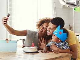 Woman taking a selfie with a man and baby