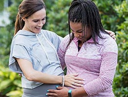 Two pregnant women supporting each other