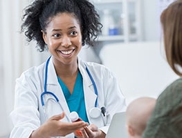 Woman taking to a smiling doctor