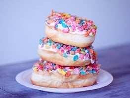 Stack of sugary doughnuts on a plate
