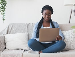 Woman sitting on a couch with her laptop
