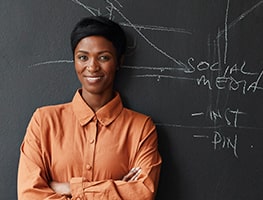 Business woman standing at a blackboard