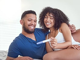 Happy couple looking at a pregnancy test