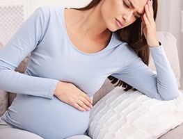 Pregnant woman in pain holding her stomach