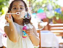 Girl blowing bubbles at a kids party venue