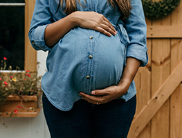 Week 39 pregnant woman holding her belly