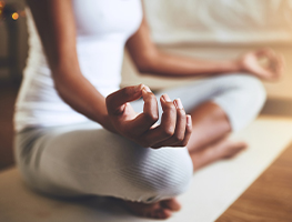 Woman sitting cross-legged in a meditative pose