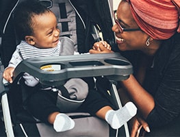 Mom chatting to her baby in a stroller