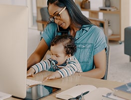 Working mom with baby on her lap