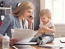 Mom working with baby on her desk