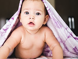 Baby with towel over his head