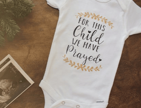 White babygrow with text