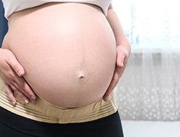 Pregnant woman holding her belly