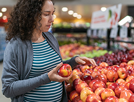 Pregnant woman buying fruit