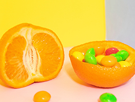 Half a citrus with candy in the skin of the other half
