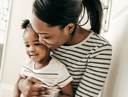 Mom hugging her toddler in the bathroom