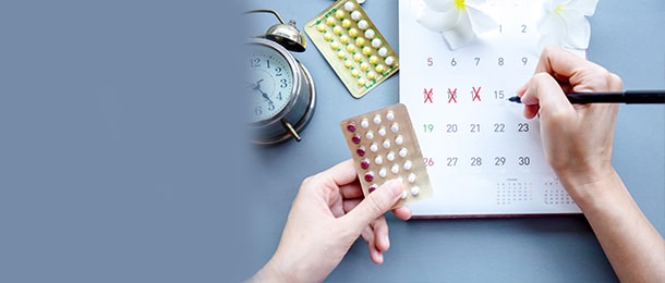 Woman marking ovulation dates on a calendar