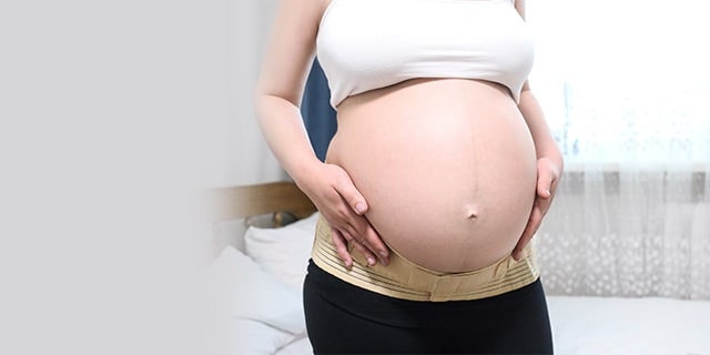 Pregnant woman holding her belly